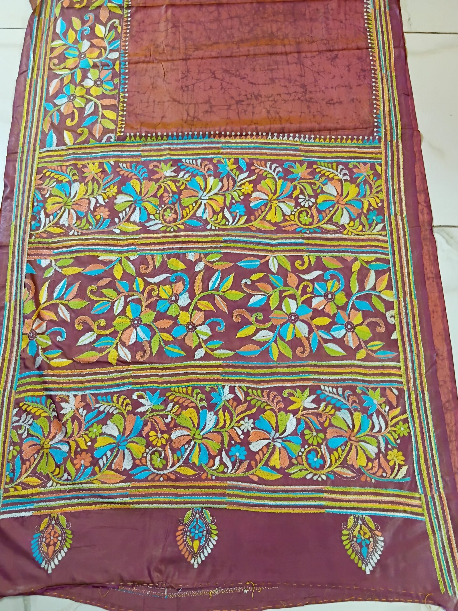 Batik Silk Kantha Stitch Saree % Handmade wax batik blended Bangalore silk Kantha stitch saree featuring beautiful batik patterns combined with intricate hand embroidery and traditional Bengal Kantha stitch work. This elegant Indian saree showcases rich textures, artistic motifs, handcrafted detailing, and traditional craftsmanship, making it perfect for festive occasions, weddings, ethnic wear, special events, and gifting.