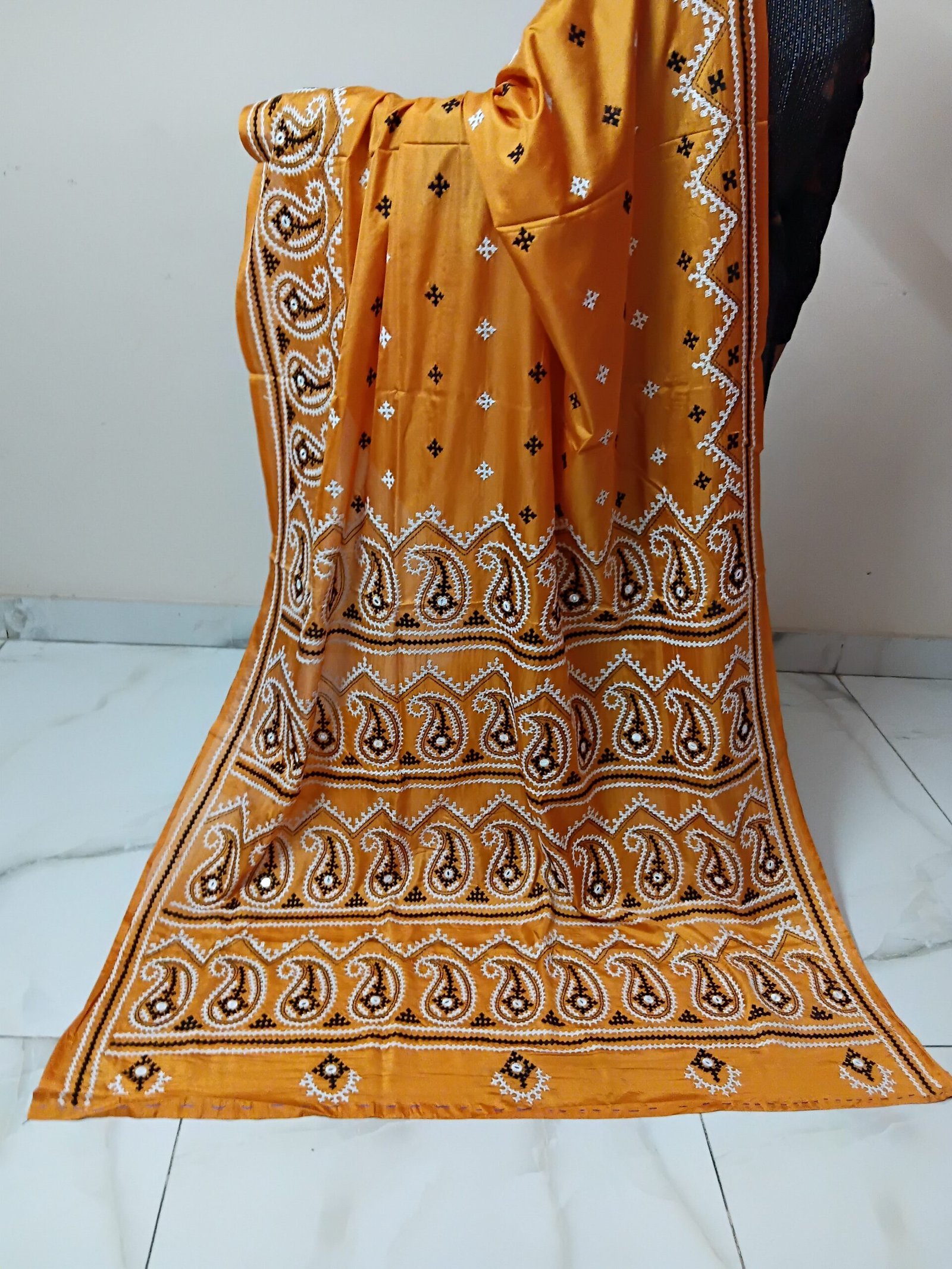 Orange Silk Gujarati Stitch Saree. Handmade Gujarati stitch blended Bangalore silk saree featuring intricate hand embroidery and traditional Bengal Kantha motifs. This elegant Indian saree showcases detailed running stitch work, rich texture, and artisanal craftsmanship, making it ideal for festive occasions, weddings, ethnic wear, special events, and gifting.