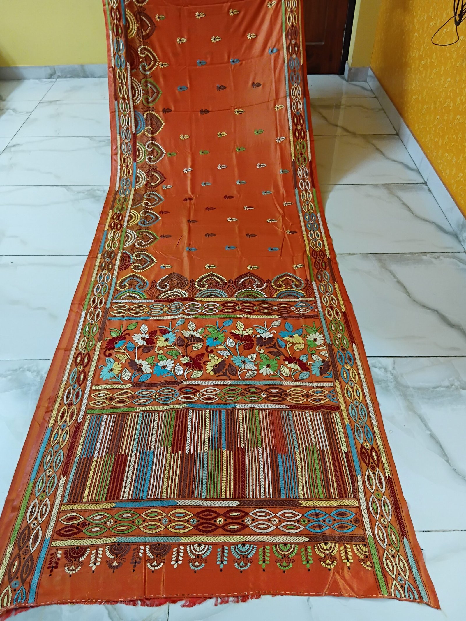 Orange Silk Kantha Stitch Saree % Orange Silk Kantha Stitch Saree. Handmade Kantha stitch blended Bangalore silk saree featuring intricate hand embroidery and traditional Bengal Kantha motifs. This elegant Indian saree showcases detailed running stitch work, rich texture, and artisanal craftsmanship, making it ideal for festive occasions, weddings, ethnic wear, special events, and gifting.
