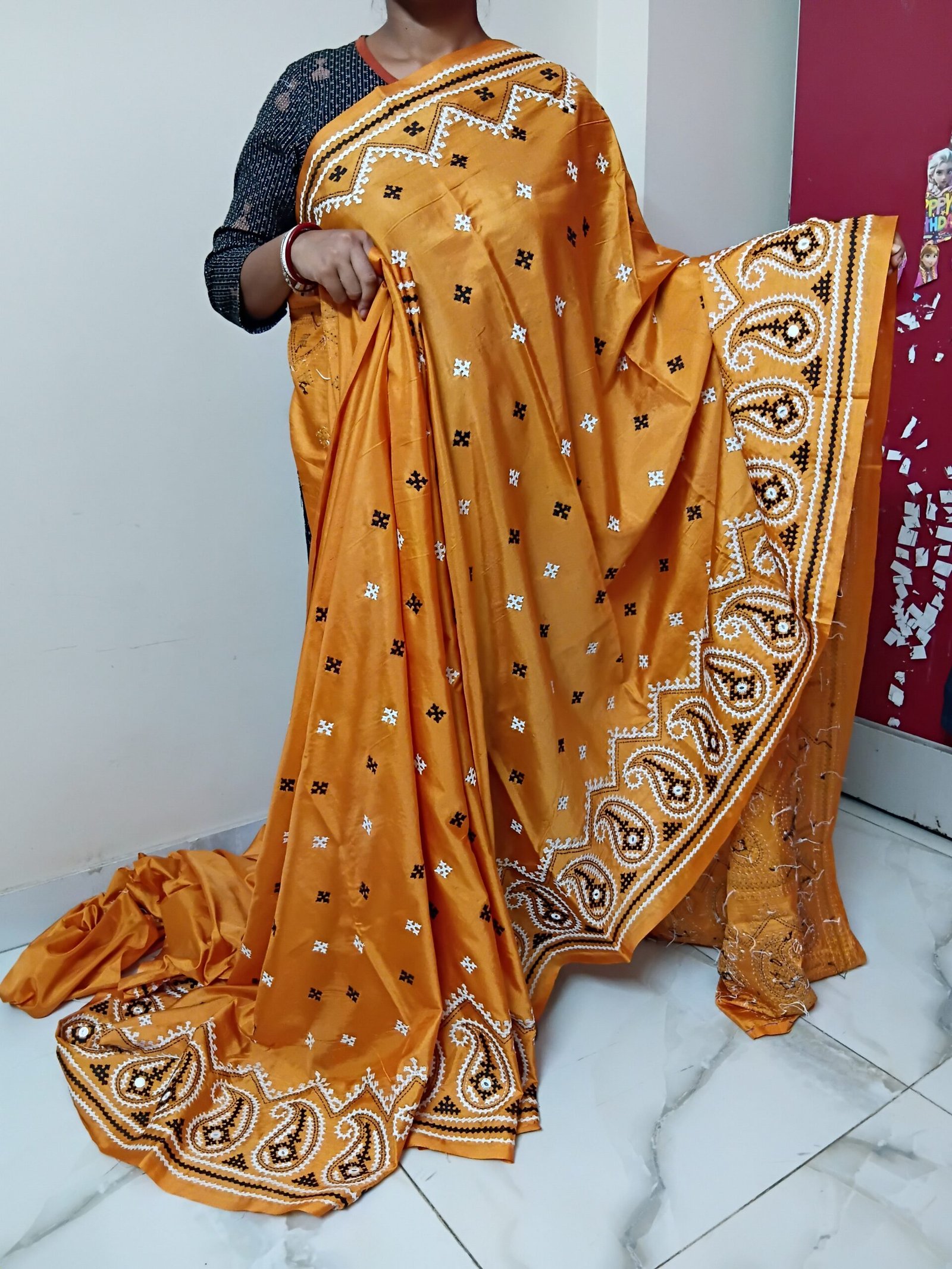 Orange Kalka Motif Gujarati Stitch Saree – Blended Bangalore Silk % Orange Gujarati Stitch saree displayed in a traditional draped style